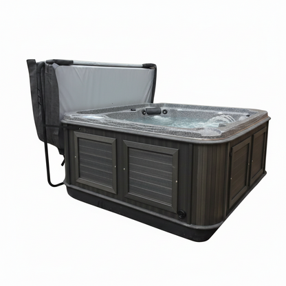 Grey Arctic Spas cover folded open on a lifter behind a charcoal-cabinet spa