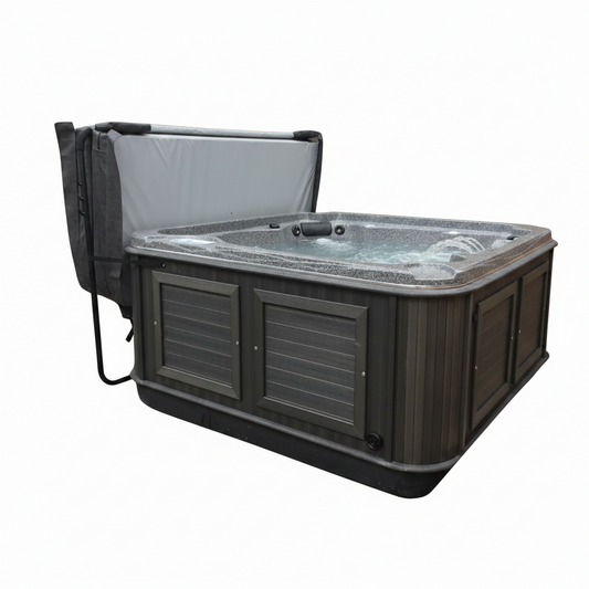 Grey Arctic Spas cover folded open on a lifter behind a charcoal-cabinet spa
