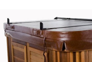 Black cover saver support bar across closed spa cover, cedar cabinet corner
