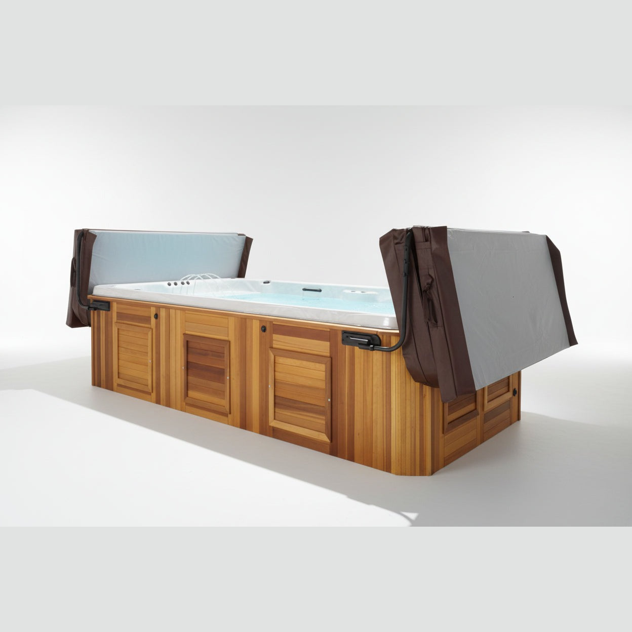 Brown two-piece swim spa cover folded open on cedar Arctic Spa